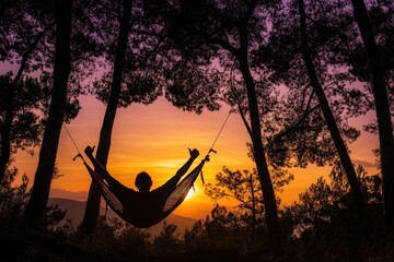 Fototapete - A person relaxing in a hammock at sunset, surrounded by trees in a serene landscape.