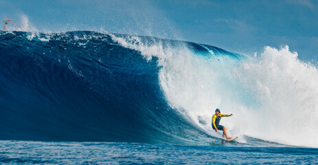 Wall Mural - Pro surfer rides big wave in the Maldives