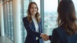 © Tasha - Businesswomen shaking hands in office, professional partnership