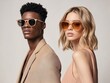 © RaptorWoman - Elegant male and female models pose confidently in fashionable sunglasses, showcasing modern style and chic beige attire.