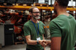 © bernardbodo - Engineers shaking hands in a modern industrial factory