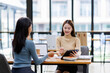© David - Two asian female creative agency casual meeting discussion working with laptop, analyze planning and financial statistics and investment market at office.