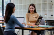 © David - Two asian female creative agency casual meeting discussion working with laptop, analyze planning and financial statistics and investment market at office.