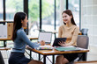 © David - Two asian female creative agency casual meeting discussion working with laptop, analyze planning and financial statistics and investment market at office.