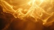 © ABIDZAR ALFAREZ - Abstract golden smoke swirls on dark background.