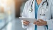 © TGIF - Healthcare professional using tablet in hospital medical environment clinical setting focused perspective for patient care