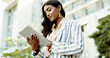 © peopleimages.com - Tablet, typing and low angle with business woman in city for communication, corporate email or travel. Networking, contact and reading with person in downtown for professional, online news and search