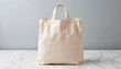 © Irina - Empty beige reusable shopping bag on marble countertop
