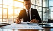 © M2A - A professional male executive skillfully reviews and signs an array of papers at a neatly organized desk, bathed in golden sunset light, enhancing the atmosphere of diligence.