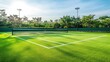 © Morto - A tranquil outdoor tennis court with a well-maintained surface and neatly arranged practice equipment, surrounded by open fields and a bright blue sky