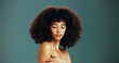 © peopleimages.com - Beauty, glow and woman with afro hair care, studio and treatment for wellness and health. Face, shoulder or confident girl model with skin, growth and natural texture on green background in Brazil
