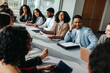 © Jacob Lund - Diverse group of professionals in a seminar setting, engaging in lively discussion around a conference table