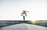Skater doing kickflip on the ramp at skate park - Stylish skaterboy training outside - Extreme sport life style concept