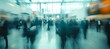 © Five Million Stock - A blurred photo of an international business exhibition, with many elegantly dressed people walking around the floor and holding brochures or looking at posters on display tables,