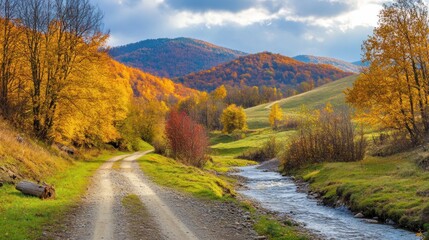 Poster - Serene Autumn Landscape: A Picturesque Country Road Winding Through Golden Foliage, a Gently Flowing Stream, and Majestic Mountains Under a Cloudy Sky