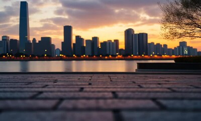 Wall Mural - Sunset view over a city skyline with a brick pathway in focus.