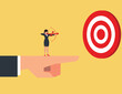 © Prasong - Business advantage or efficiency. Businesswoman Standing and holding a bow on the giant hand pointing to the target
