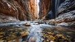 © Nosheen - High-end photography of a secluded river gorge with steep rock walls and a flowing waterfall