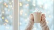 © Ryzhkov - Cozy Winter Moment Childs Hands Holding Hot Cocoa by Festive Window