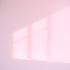 a pink wall with a reflection of the sun on it