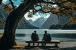 © MDOMAR - Two men sit on a wooden bench under a large tree, each holding a backpack,