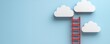 © Rossarin - A red ladder leans against white clouds on a blue background, symbolizing aspiration and reaching for dreams.
