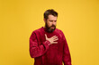 © Lustre Art Group  - Portrait of young sick man coughing holding hand on breast and deeply breathing against bright yellow background. Concept of healthcare,, medicine, health insurance. ad