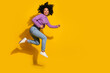 © deagreez - Full size photo of nice young woman run jump empty space isolated on yellow color background