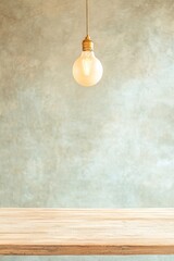 Poster - Minimalist Hanging Bulb Over Wooden Table in Soft Focus Background