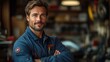 © afridwi - Confident man in work attire posing in a workshop.