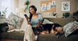 © peopleimages.com - Woman, headphones and dog for music in home, surfing audio website and online for playlist search. Female person, hearing podcast and app for communication on couch, pet care and internet for sound