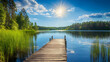 © mahamad - A traditional Finnish landscape showcasing a beautiful lake on a summer day, complete with a rustic wooden dock and sunlit forest.