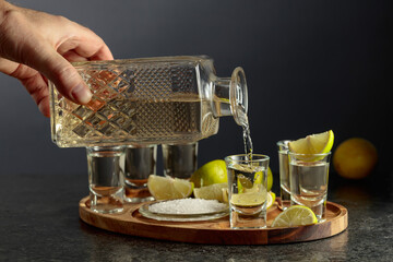 Wall Mural - Gold tequila with salt and lime slices.