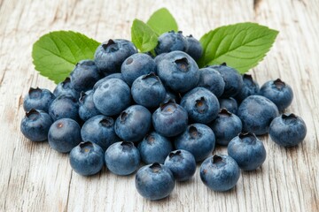 Wall Mural - Fresh blueberries arranged on a wooden surface with leaves in natural light