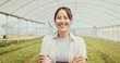 © peopleimages.com - Happy, sustainable and portrait of woman in greenhouse for agriculture, eco friendly or natural produce. Crossed arms, environment and face of Asian female farmer for indoor gardening with vegetables