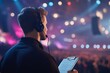 © yanto - A technician monitors an event with a clipboard and headset.