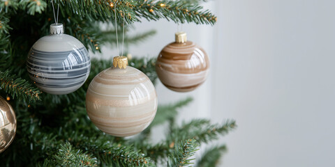 Poster - Stylish modern design Christmas baubles balls neutral color beige tones hanging on tree branches close up detail. 