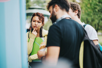 Poster - A diverse group of students spends time together in a park during a break between classes, displaying camaraderie and relaxation in an educational setting.