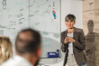 © Zamrznuti tonovi - Young businesswoman leading a meeting, explaining a project to her team in the office