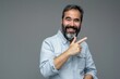 © Harsha - Happy Hispanic man with beard pointing and smiling at camera.
