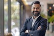 © Harsha - Confident Indian CEO standing with arms crossed in business portrait.