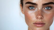 © gnoparus - Close-up of Freckled Woman with Blue Eyes and Natural Makeup