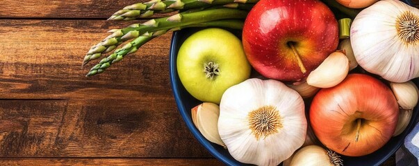 Wall Mural - A vibrant bowl of prebiotic foods such as garlic, onions, asparagus, and apples, styled on a wooden countertop with natural lighting