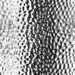 Wall Mural - Close-up of shimmering water droplets on glass.