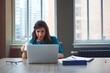 © peopleimages.com - Coffee, business woman and laptop in office for asset management, review client profit data and revenue. Financial advisor, employee and reading report for retirement planning and investment strategy