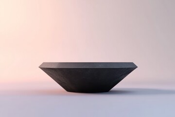 Leinwandbilder - Facetted dark grey stone bowl on white background.