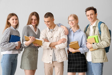 Canvas Print - Group of students with books on grey background