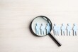 © Vadym - Magnifying glass focuses on group of people. Finding ideal candidate. Job hunt concept. Recruitment process. Headhunting strategy. Human resources department. Hiring. Job search. Resume submission.