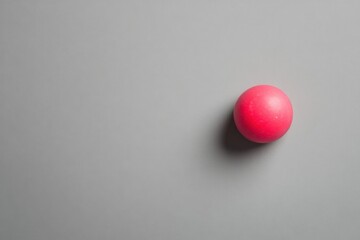 Wall Mural - A single pink sphere rests on a gray background