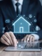 © Vadym - Businessman using laptop to manage real estate. Virtual house model appears on laptop screen. Online real estate services, home insurance. Concept of buying, selling houses online. Modern tech for